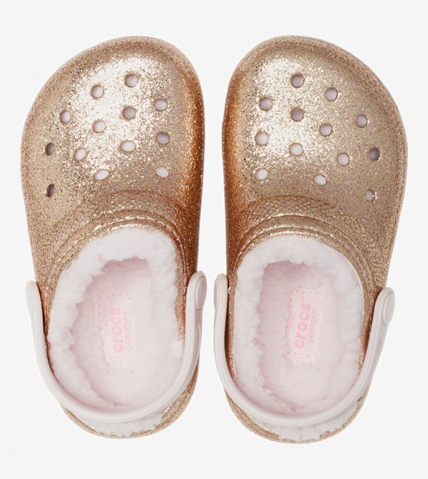 gold crocs with pink fur